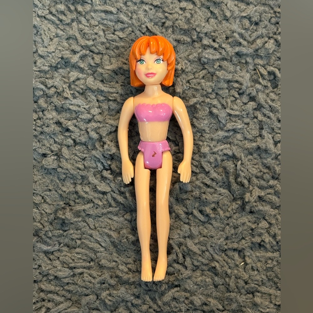 Lightly used Polly Pocket with short orange hair and pink undergarments